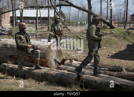 Srinagar Kashmir. 22 Mar, 2019. Esercito indiano troopers guardia vicino al sito di un gunfight in Hajin villaggio del distretto di Bandipora, circa 40 km a nord di Srinagar, la capitale estiva del Kashmir, Marzo 22, 2019. Sei militanti e un 12-anno-vecchio ragazzo sono stati uccisi in tre distinte sparatorie feroci in irrequieta Kashmir, funzionari detto venerdì. Credito: Javed Dar/Xinhua/Alamy Live News Foto Stock