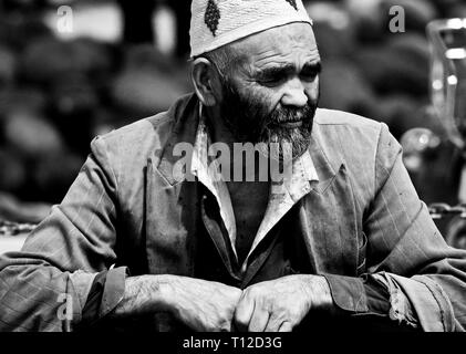 Vecchio uomo Uighur sul famoso mercato domenicale a Kashgar, regione autonoma di Xinjiang, Cina. Foto Stock