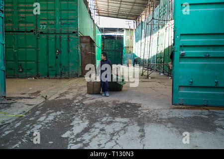 Al Dordoy Bazaar, uno di Asia il più grande dei mercati all'ingrosso a Bishkek, Kirghizistan. Tutte le stalle sono in contenitori di spedizione. Lavoro infantile. Foto Stock