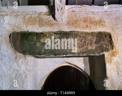 Una C5a-6a quadrilatero inscritto in pietra del montante orizzontalmente per formare un architrave su N porta dentro di St Baglan la Chiesa, Llanfaglan, Caernarfon, Galles Foto Stock