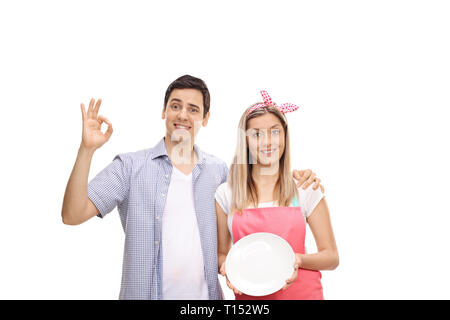 Coppia giovane che mostra una piastra pulita isolati su sfondo bianco Foto Stock