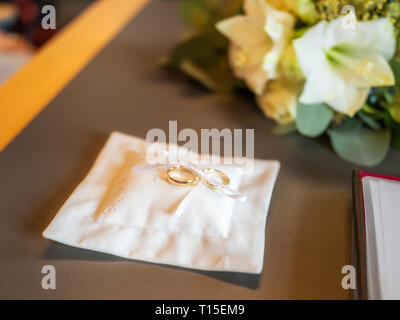 Close-up di anelli di nozze su una bianca chushion Foto Stock