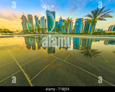 Skyline di Doha, Qatar al Cielo di tramonto. Scenic cityscape di West Bay skyline mirroring nell'acqua del parco cittadino. Medio Oriente, Penisola Arabica in Foto Stock