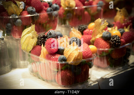 Close-up di frutta colorata in scatole di plastica al mercato Foto Stock