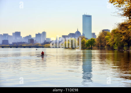 Canottaggio nel fiume Charles su una mattinata nebbiosa. Boston skyline della città in background Foto Stock