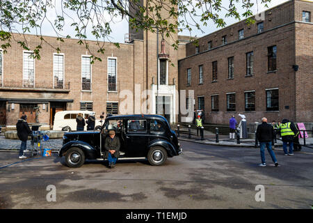 Crouch End, Londra, Regno Unito. Il 26 marzo 2019. Un equipaggio di produzione film una scena per 'Pennyworth', un imminente American Drama serie TV con i primi anni di vita di Batman ha fedeli butler Alfred. L'art deco town hall è un luogo molto popolare per film e produzioni TV. Credito: Michael Heath/Alamy Live News Foto Stock