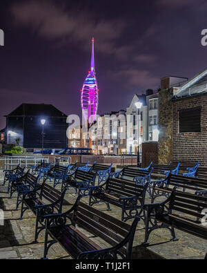 Spinnaker Tower illuminato di viola di notte presi dal vecchio Portsmouth con panche in primo piano Foto Stock