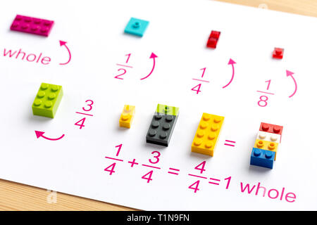 Il bambino mette i blocchi colorati nel posto giusto. Math giochi per bambini. Matematica, logica, formazione Foto Stock