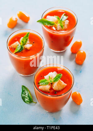 Una deliziosa zuppa gaspacho in vetro. Spagnolo tradizionale zuppa fredda purea o gaspacho gazpacho sul cemento grigio Sfondo. Vista da sopra o vista superiore piatta o laici. Verticale. Foto Stock