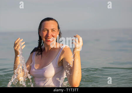 Donna anziana in acqua di mare. Donna di mezza età la balneazione nell'oceano. Foto Stock