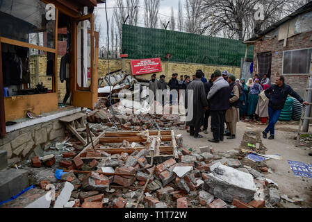 I residenti del Kashmir sono visto in piedi vicino a un veicolo danneggiato dopo un esplosione. Relazioni ha detto che il panico afferrata in Alochi Bagh area di Srinagar quando un misterioso blast ha avuto luogo nelle vicinanze dell'esercito indiano del camp nella zona. Una casa e un veicolo parcheggiato sono state danneggiate a causa dell'impatto dell'esplosione. Foto Stock