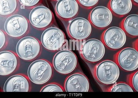 Rosso di lattine in alluminio imballati in plastick sfondo, vista dall'alto Foto Stock