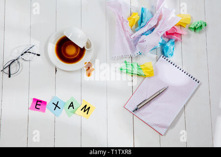 Articoli di cancelleria e di esame di parola fatta di lettere sullo sfondo di legno. Istruzione, college, scuola, stress, università, studenti che studiano concetto. Appartamento laici o vista superiore Foto Stock