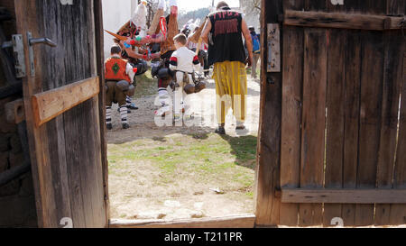 Turia, Bulgaria, 9 marzo 2019. Masquerade Kukeri rituale per espellere il male. La gente del villaggio di usura campane grande e terribile costumi. Foto Stock