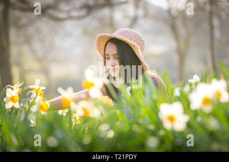 . Ellie May, otto anni, gode dei fiori di primavera, mentre il Regno Unito ha un fine settimana di sole e calore prima che le temperature scendano la prossima settimana. Credit: Peter Lopeman/Alamy Live News Foto Stock