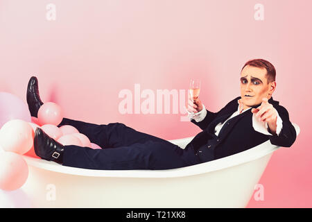 Volete unirvi a me. Attore Mime godetevi il bagno nella vasca da bagno. La balneazione e rilassante. Mime è l'uomo festa con champagne. Attore comico celebrare Foto Stock