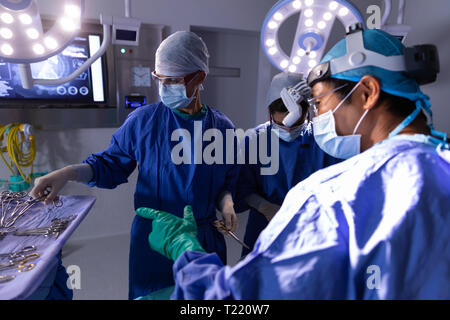 Chirurghi in sala operatoria durante un intervento chirurgico in ospedale Foto Stock