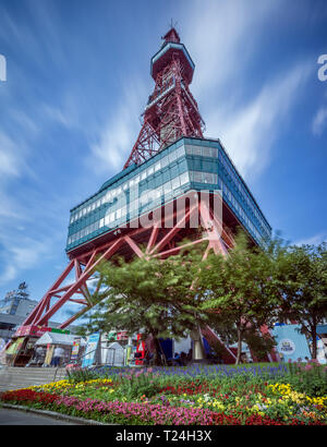 Hokkaido, Agosto 02, 2016. Verticale vista surround di Sapporo torre della TV dal Parco Odori giardini con cloud sfocata striature. Foto Stock