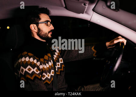 Uomo alla guida di auto di notte Foto Stock