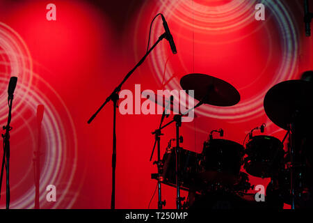 Silhouette di un drum set di fronte red stage light Foto Stock