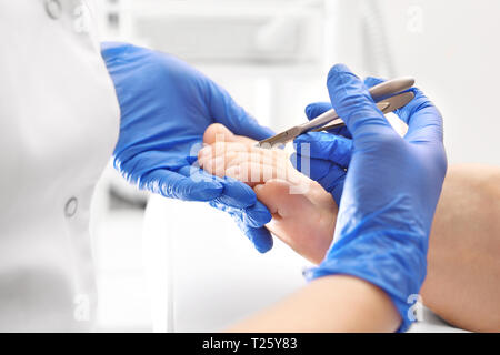 Pedicure, il taglio di cuticole ed unghie di taglio all'estetista. Foto Stock