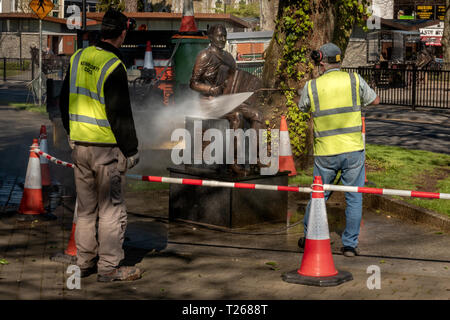 Lavoratori del consiglio con pulitore a pressione il fisarmonicista Johnny o'Leary Monument pulizia primaverile a Killarney, nella contea di Kerry, Irlanda Foto Stock