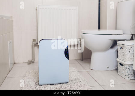 Deumidificatore con pannello a sfioramento, indicatore di umidità, lampada UV, ionizzatore d'aria, il contenitore dell'acqua lavora a casa in bagno. Essiccatore di aria Foto Stock