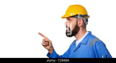 Barbuto builder in elmetto, foreman o aggiustatore nel casco giallo poiting il suo dito nel ritratto di profilo generatore di architetto, di ingegnere civile workin Foto Stock
