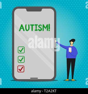 Segno di testo che mostra l'autismo. Business photo testo di sensibilizzazione sull'Autismo condotta dal comitato sociale in tutto il mondo l'uomo presentando un enorme schermo vuoto Smartph Foto Stock