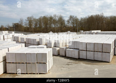 Vista della fabbrica di produzione di vegetali autoclavato calcestruzzo aerato. Molti pacchetti di blocchi su pallet mettere uno sull'altro in un magazzino esterno. Vista superiore Foto Stock