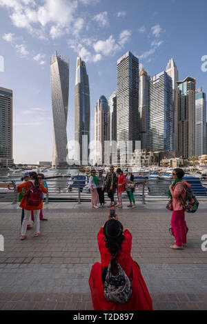 Turisti asiatici in posa per fotografie a Dubai Marina, Dubai, Emirati Arabi Uniti Foto Stock