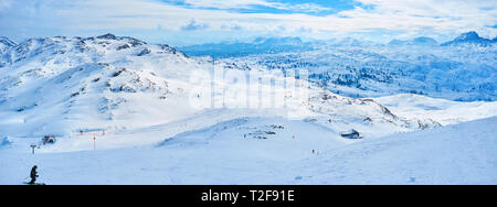 Inverno panoramica sullo skyline alpino del massiccio Dachstein dai pendii innevati di Krippenstein mount con numerose piste da sci e showshoers' rotte, Salzk Foto Stock