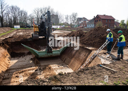 02 aprile 2019, Bassa Sassonia, Göttingen: Un escavatore scava un campo di prova di circa 2500 metri quadrati sulla prova Reinshof farm. Gli effetti della metropolitana linee di potenza sul terreno lungo la prevista linea elettrica ad alta tensione sono Wahle-Mecklar per essere simulato sulla superficie a nome della griglia operatore Tennet e studiato da scienziati agricoli presso l'Università di Göttingen. Foto: Swen Pförtner/dpa Foto Stock