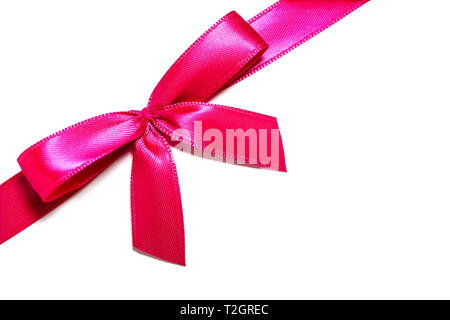 Pink Ribbon regalo di prua. Rosa rosso nastro di raso con fiocco annodato dono di avvolgimento a nastro per il regalo di Natale isolato tagliato su un semplice sfondo bianco. Foto Stock