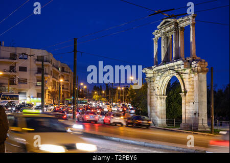 Il traffico pesante che passa l'Arco di Adriano su Leoforos Amalias Vasilisis di notte, il centro di Atene, Grecia. Foto Stock