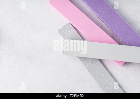 Colorato nail files su sfondo grigio. Manicure e pedicure strumenti. Foto Stock