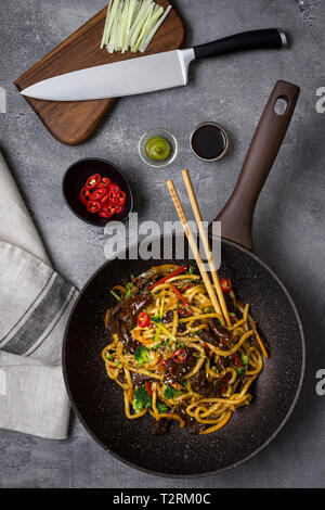 Udon Tagliatelle con manzo e verdure preparato in padella Wok su sfondo scuro Foto Stock
