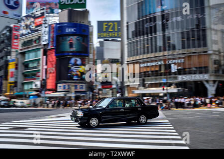 Nella foto è una vettura guida su un incrocio di Shibuya di Tokyo in Giappone. Foto Stock