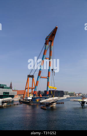 Copenhagen, Danimarca - 4 Aprile 2019: l'enorme gru galleggiante Hebo sollevare 9 installazione di parti per un nuovo ponte in bicicletta sul porto. Foto Stock