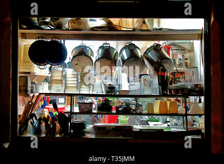 Pentole e altri strumenti dello chef e appeso su un ripiano nella finestra di un ristorante. Foto Stock