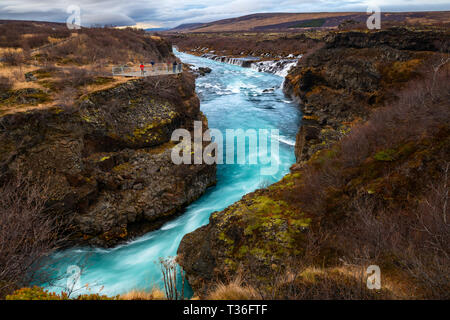 Hraunfossar ("cascate di lava" in inglese) nel distretto di Borgarfjörður è una serie di belle cascate formate da ruscelletti streaming fuori del Hallmundar Foto Stock