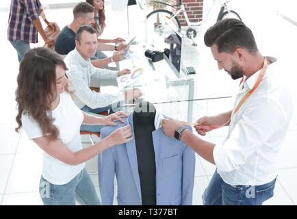 Progettisti che lavorano su nuovi modelli di vestiti Foto Stock