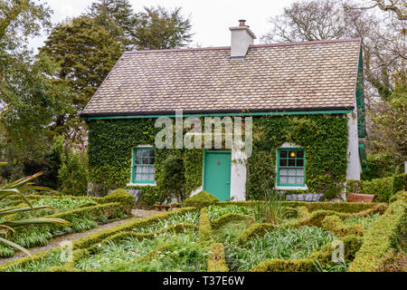 Piccolo grazioso cottage irlandese, con un curatissimo giardino con siepi di bosso. Foto Stock