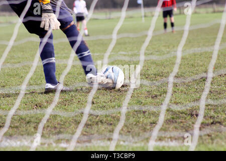 Close up di un portiere prendendo un obiettivo calcio Foto Stock