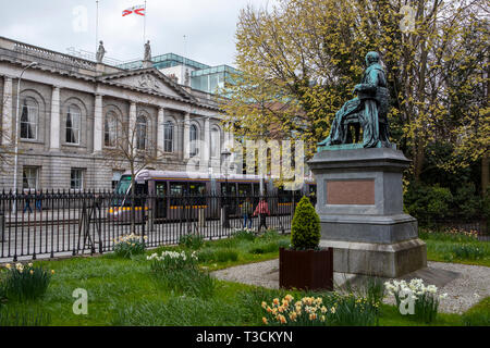 Il tram Luas passa Lord Ardilaun statua su Saint Stephen's Green, Dublino Foto Stock