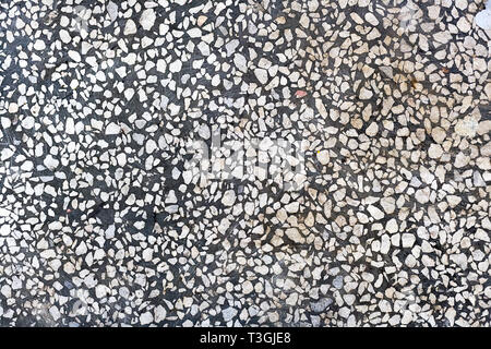 Abstract background. Grigio a pavimento di cemento con pietra bianca di chip. Superficie levigata liscia. Foto Stock