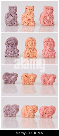 Varie vitamine per bambini su uno sfondo bianco. Luci dello studio. Assortiti a forma di animale polivitaminico per bambini. Compresse masticabili Foto Stock