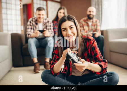 Happy amici con joystick riproduce video console Foto Stock