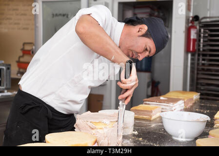 Pastry Chef preparare una torta in pasticceria cucina . Foto Stock