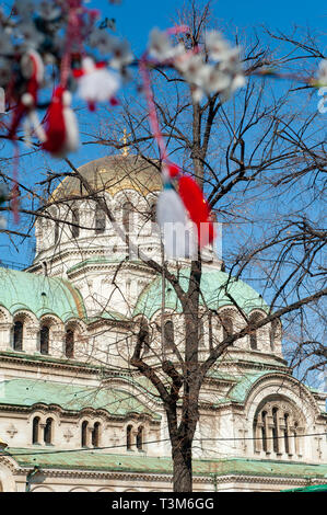 Martenitsi appeso al ramo di un albero esterno Cattedrale Alexander Nevski, Sofia, Bulgaria, l'Europa. Foto Stock